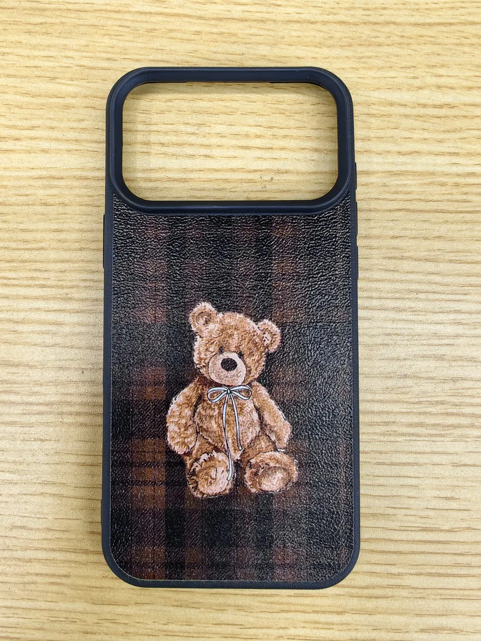 Finished brown plaid teddy-bear phone case showing its flat print and camera opening